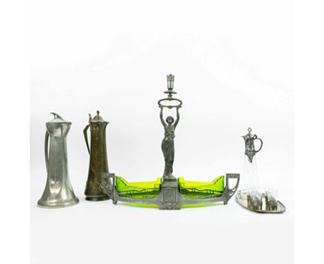 WMF. AN ART NOUVEAU CENTERPIECE. (4). with a figural candlestick and green glass liners along with a WMF liquor set and two s