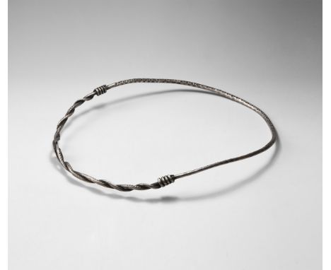 9th-11th century AD. A silver two-part neck-ring comprising a round-section portion with triangular stamps to the upper face,