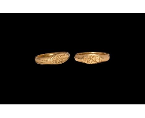 6th-7th century AD. A gold finger ring comprising a D-section hoop with keeled shoulders, scaphoid plaque with crosses flanki