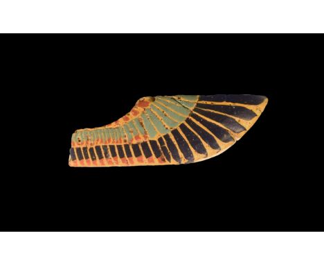 Ptolemaic Period, 332-30 BC. A fused glass wing appliqué with dark blue, light blue and red feather detailing on a yellow bac