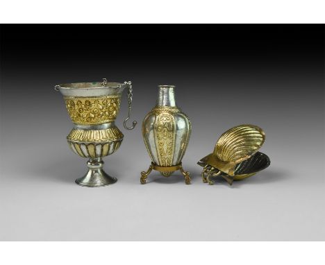 7th-9th century AD. A mixed group of silver-gilt liturgical items comprising: a hanging lamp with flared foot, carinated segm