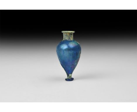 2nd-1st century BC. An iridescent blue glass unguentarium with irregular narrow applied base, horizontal flared rim. Cf. Ligh