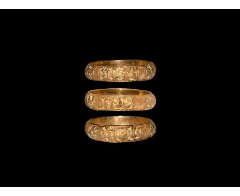 15th century AD. A gold finger ring with D-section hollow-formed hoop, three rosettes to the outer face with interstitial pan