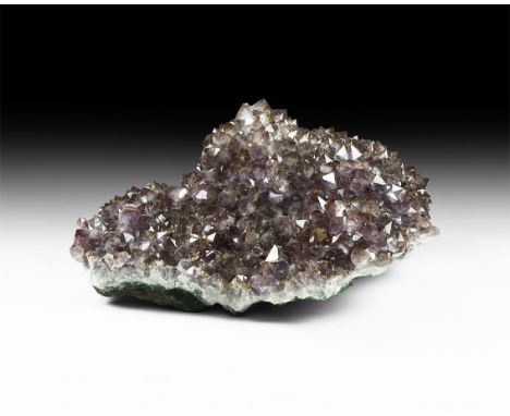 A large geode fragment with raised cushion, dense amethyst crystal growth.  33.4 kg, 45cm (17 3/4"). From the former stock of
