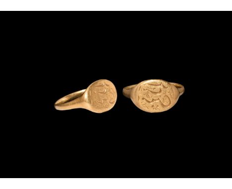 18th century AD. A gold finger ring comprising a flat-section hoop and discoid plaque with incised cursive inscription and te