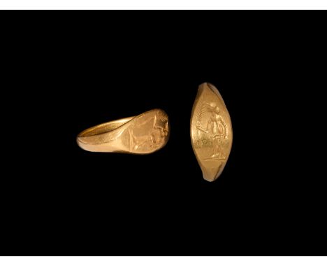 2nd-3rd century AD. A gold finger ring comprising a slender tapering hoop, ellipsoid bezel with intaglio standing figure of V