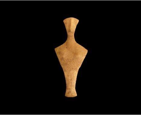 4th-3rd millennium BC. A fine grained marble figure of a stylised female; flat, fan-shaped head with long prominent nose ridg