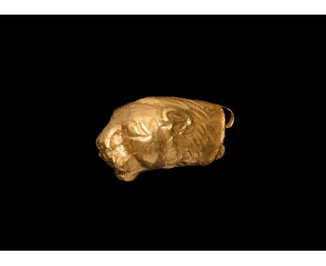 1st millennium BC. A gold amulet in the form of a roaring lion head made from a single gold sheet; suspension ring to the bac