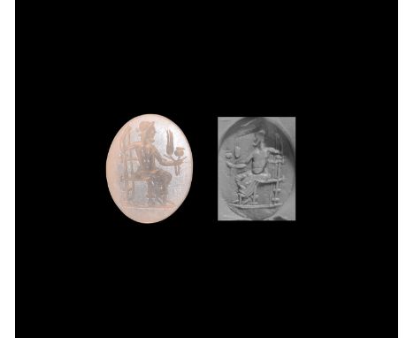 2nd-3rd century AD. An oval white chalcedony intaglio gemstone engraved with a seated deity facing right, holding sceptre and
