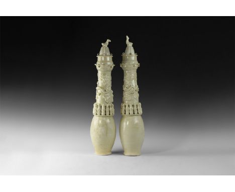 Song Dynasty, 960-1127 AD. A group of two cream-glazed ceramic granary jars each with a row of facing guardian figures and dr