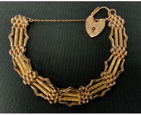 A 9ct gold fancy link gate bracelet, padlock clasp,. 1.4cm wide, 15.2g 