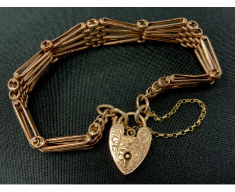 A 9ct rose gold tapering fancy bar gate bracelet, pad lock clasp, 1.3cm wide, 19.4g 