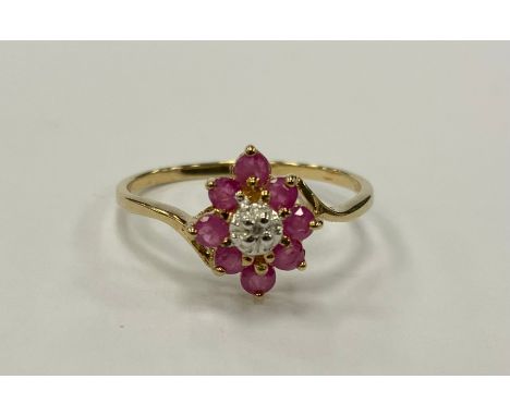 A ruby and diamond cluster ring, central diamond approx 0.02ct, surrounded by eight pink rubies, total estimated ruby weight 