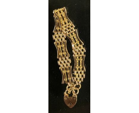 A 9ct gold textured bar gate bracelet, pad lock clasp, 1.4cm wide, 14.9g 