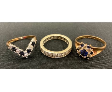 A 9ct gold sapphire and diamond effect V ring;  similar cluster ring,  5.3g gross,  white metal half eternity ring, marked 9c