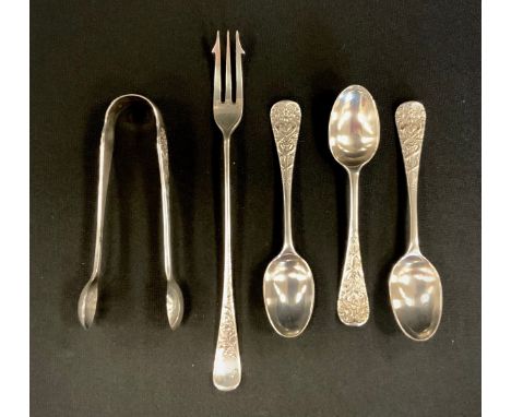 A pair of Victorian silver sugar tongs, and three spoons, cast with  Swans, Serpents and floral motifs, Wakely &amp; Wheeler 