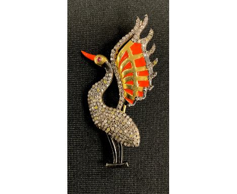 An Art Deco style diamond, ruby and enamel pendant brooch, as a fanciful wading bird, with orange beak and wings, ruby eye, r