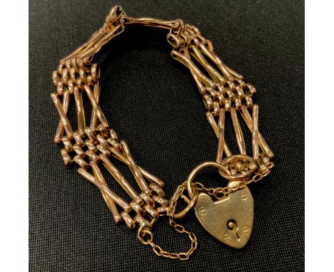 A 9ct gold X bar cross link gate bracelet, padlock clasp, 1.5cm wide, 18.1g 