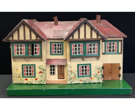 A vintage mid 20th century two storey dolls house with assorted furniture, 43cm x 68cm x 42cm 