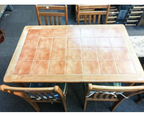 A tile top kitchen table and a set of four chairs