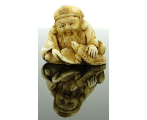 Late 19th century carved ivory netsuke
depicting a man with a turtle, signed, height 1.1".