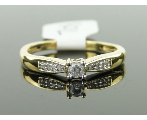 An 18ct gold solitaire diamond ring,
with diamond set shoulders, size M.