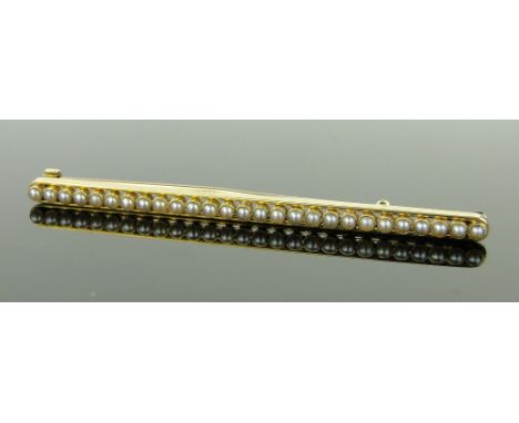 A 15ct gold pearl set line brooch,
length 65mm.