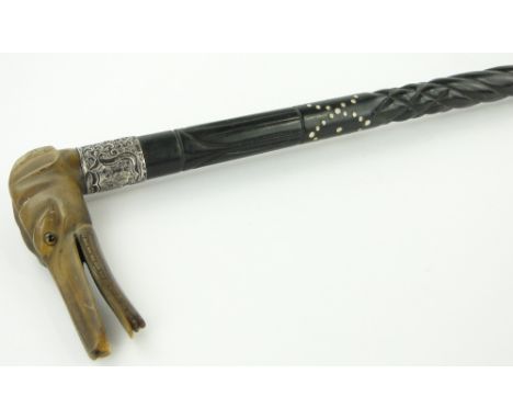 Carved ebony walking stick
with carved horn dogs head handle.