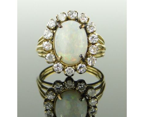 An opal and diamond cluster ring,
unmarked gold settings, setting height 17mm, size M.