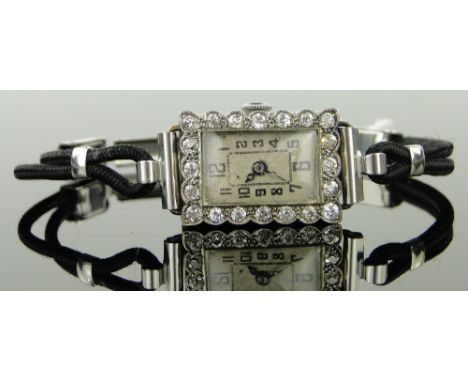 A lady's Art Deco 18ct white gold and diamond cocktail wristwatch,
case width 15mm.