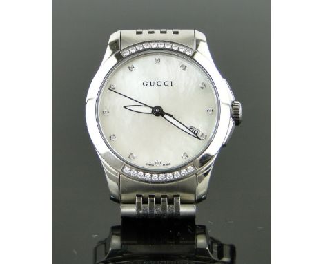 A lady's Gucci G-Timeless wristwatch,
stainless steel case with mother of pearl and diamond dial, case width 28mm, boxed with
