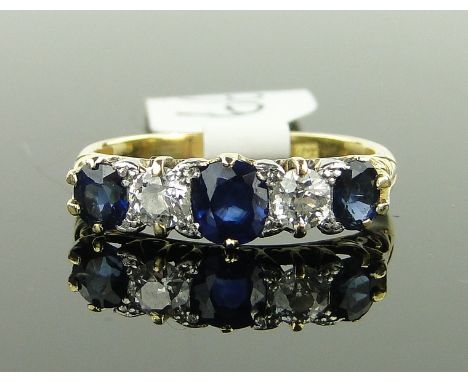 An 18ct gold 5-stone sapphire and diamond ring,
diamond content approx 0.24cts total, sapphires approx 1.1cts total, size K.