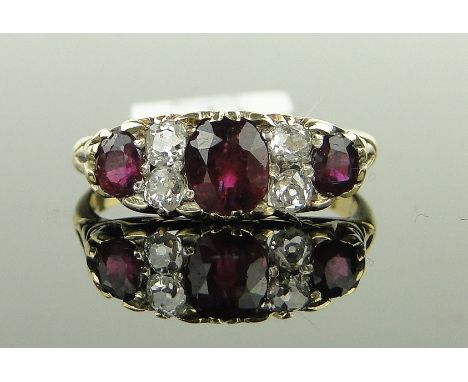 An 18ct gold 7-stone ruby and diamond ring,
total ruby content approx 1.4cts, size O.