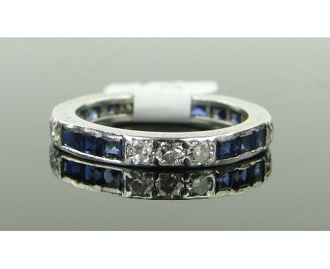 A platinum, sapphire and diamond eternity ring,
size K.