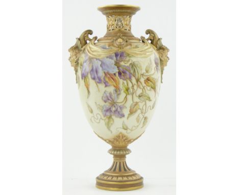 A Royal Worcester vase
with mask handles and painted and gilded floral design, 1407, 15.75".