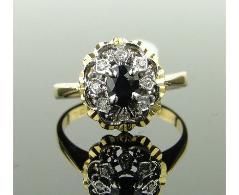 An 18ct gold sapphire and diamond cluster ring,
size N.