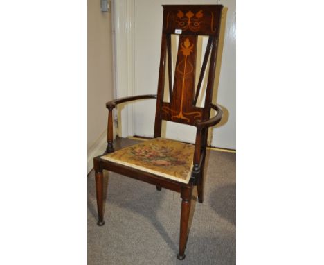 An Art Nouveau high back hall chair,
having stylised marquetry decoration and bow arms raised on turned legs.