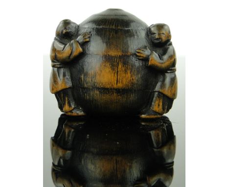 An 18th century boxwood netsuke
depicting boys around a stack, height 1.2".