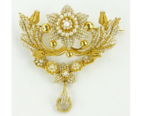 An ornate unmarked gold filigree and seed pearl brooch,
with articulated swags and pendants below, width 55mm, height 60mm.