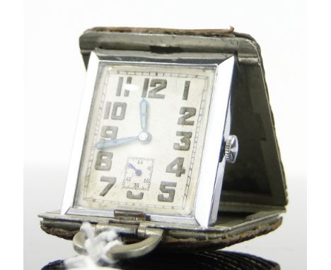 A Swiss Art Deco snake skin and chrome folding travelling timepiece,
circa 1930, case width 34mm.