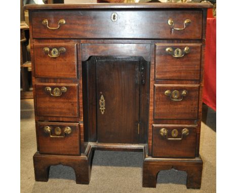 An 18th century mahogany writing desk,
having a single frieze drawer with recessed panelled cupboard under, flanked by short 