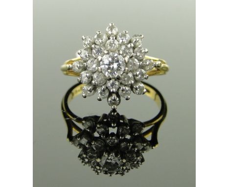 An 18ct gold diamond cluster ring,
setting height 15mm, size M.