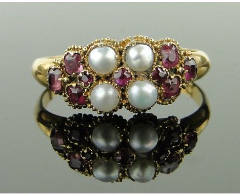 An Edwardian 18ct gold ruby and pearl set ring,
size Q.