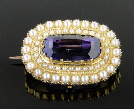 An amethyst and pearl set oval brooch,
unmarked gold settings, 25mm across.