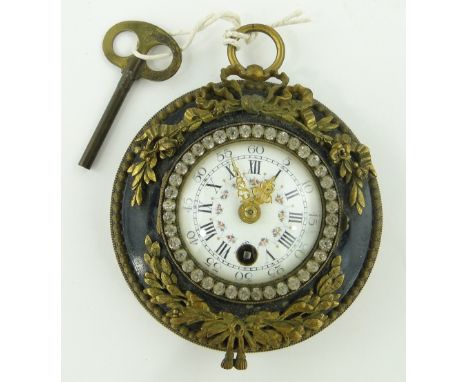 A small antique French wall clock
with ormolu mounts and paste set bezel, diameter 4.75". 