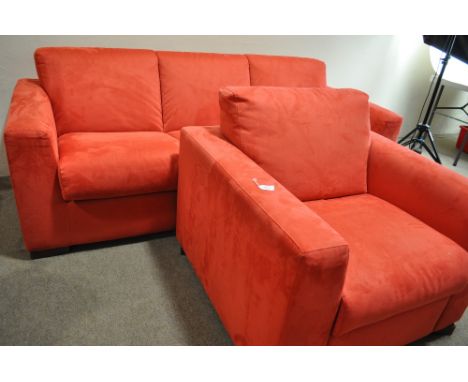 An Italian red suede sofa bed and matching armchair by Nattuzi.