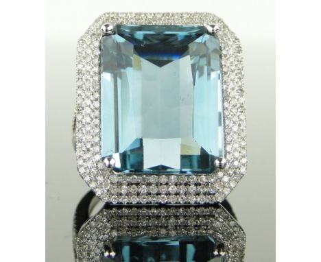 A large 14ct white gold aquamarine and diamond ring,
aqua approx. 24cts, diamond content approx. 1.25cts total, setting heigh