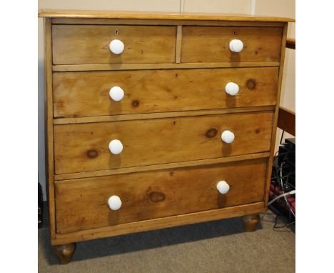 A Victorian pine 5 drawer chest,
having white ceramic handles raised on bun feet, width 3'5", height 3'4", depth 19".