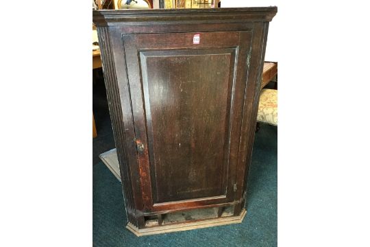 An Antique Corner Cabinet With Moulded Cornice Above Fielded