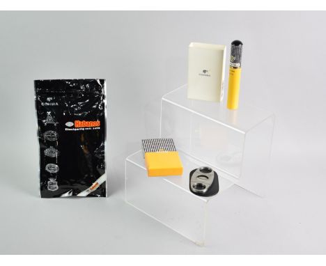 A Cohiba Siglo II, A Boxed Cohiba Cigar Cutter and a Pack of Three Habanos Cigars